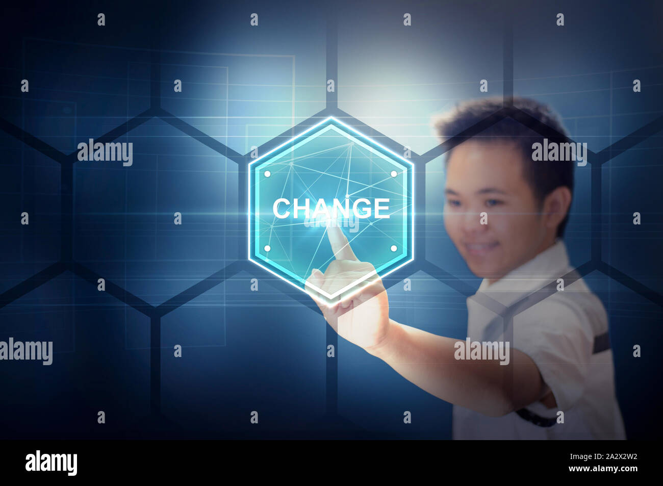 Young Man Touching a Hexagon Plate Virtual Button On a Virtual Hologram Screen. Modern Technology and Futuristic Concept. Man Stock Photo