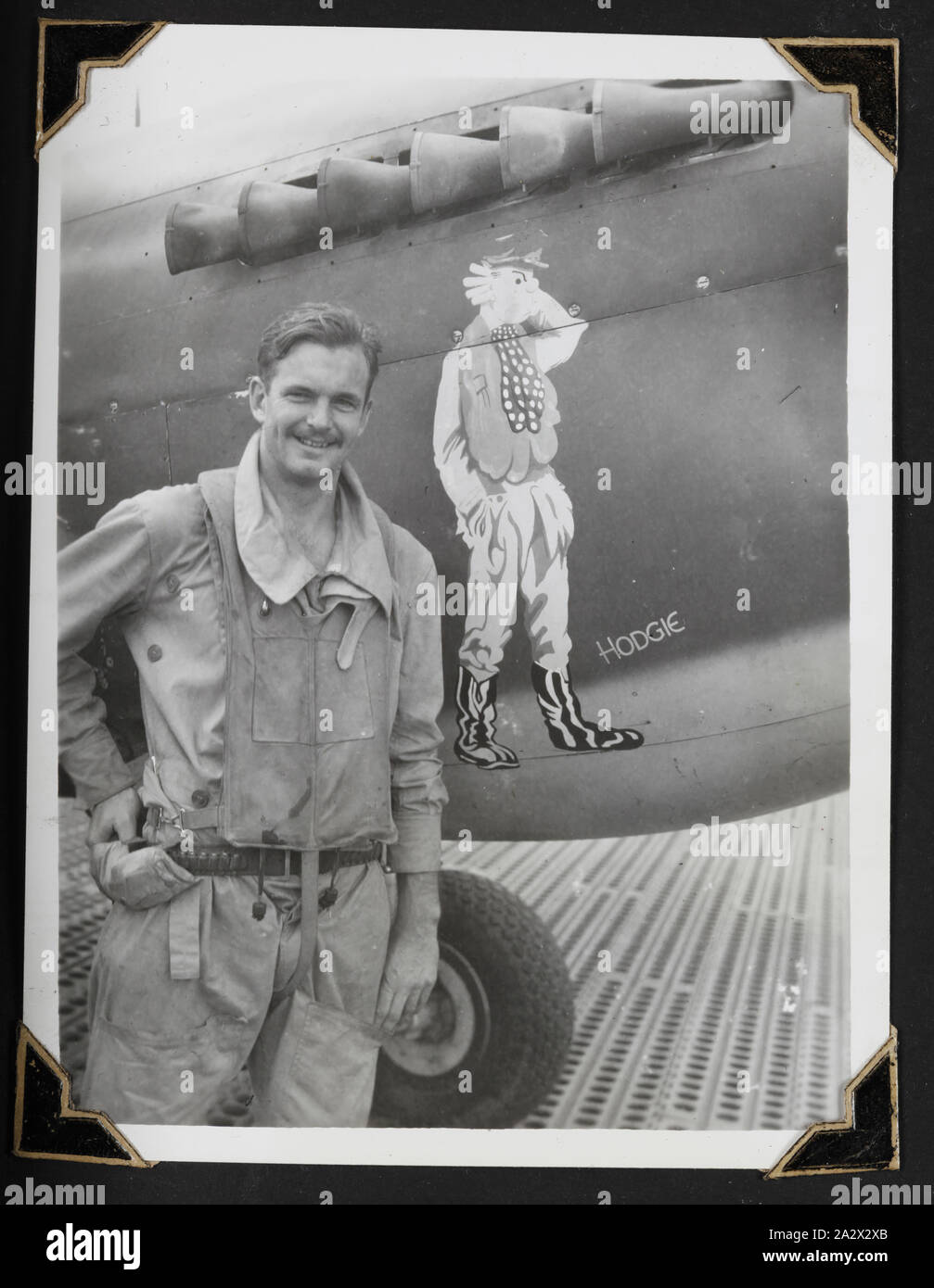 Photograph - 'F/O J.A.T Hodgkinson & Aircraft Mascot', New Guinea, 1942-1945, Black and white photograph of Flying Officer (F/O) J.A.T Hodgkinson. One of 116 photographs in a photographic album held by Pilot Officer Colin Keon-Cohen. These are very good images of life in Singapore with 205 Sqn RAF, then 77 Sqn RAAF, World War II era Stock Photo