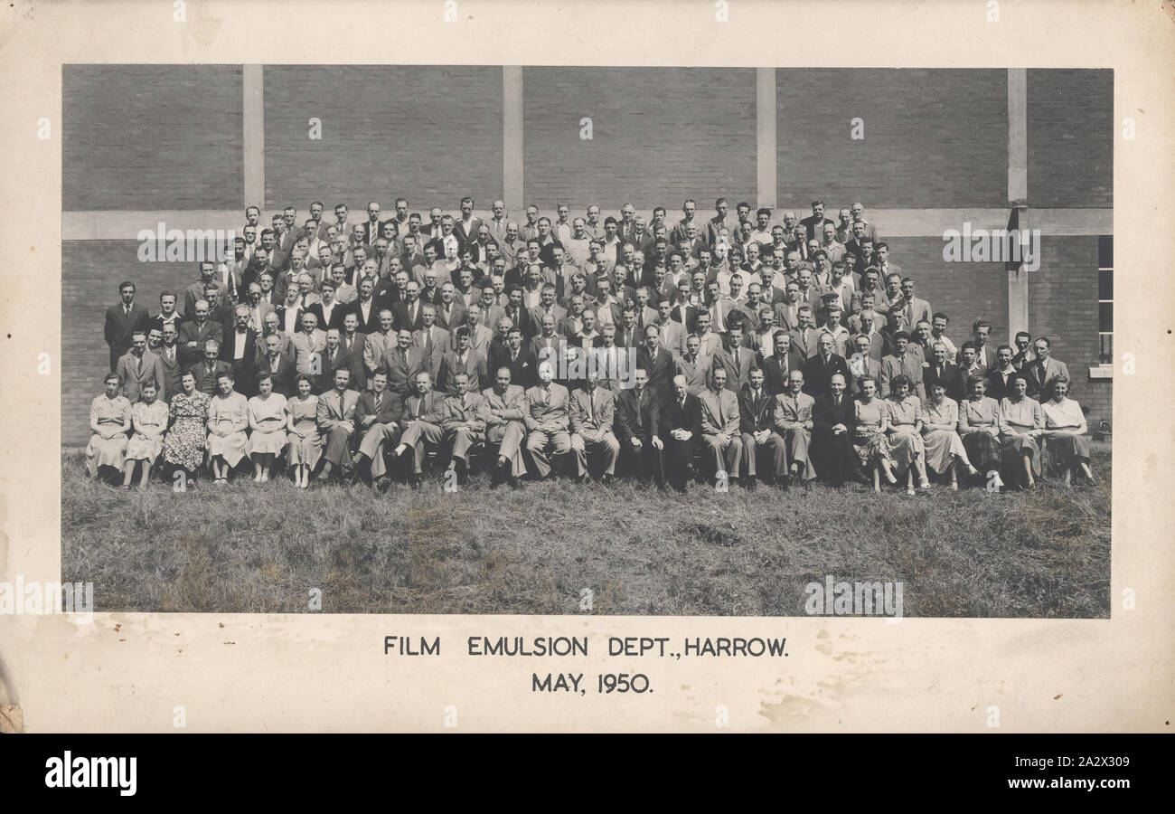 Photograph - 'Film Emulsion Dept., Harrow.', Kodak Limited, Harrow, England, May 1950, Black and white photograph of staff from the Film Emulsion Department at Kodak Limited, Harrow, England, taken May 1950. The photograph features over one hundred men and women staff seated and sitting in front of a Kodak factory building. This photograph is related to a number of other photographs and a manuscript written by Margaret D Gauntlett, titled 'A History of Kodak Limited', issued by Stock Photo