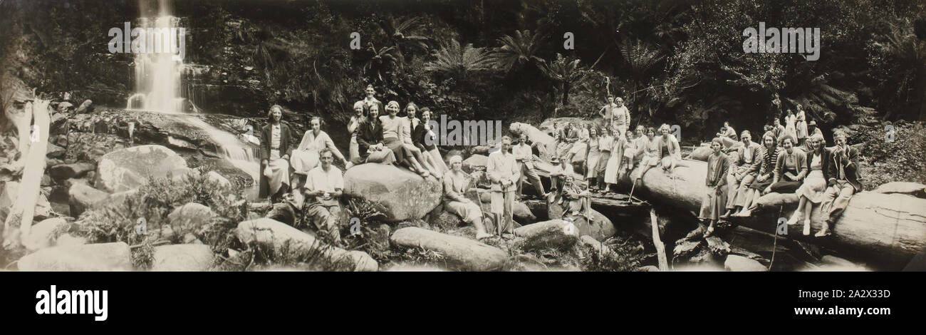 Photograph - Group Portrait in Bushland, Lorne District, Victoria, circa 1928, Black and white photograph depicting a group of men and women arranged on rocks and fallen trees. in December 1899 and began a strong association with Lorne Stock Photo