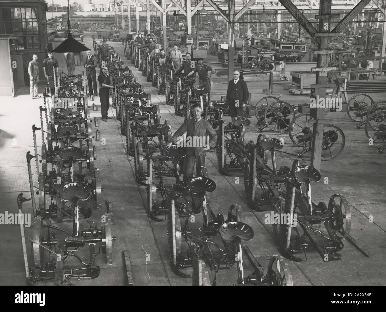Photograph - H.V. McKay Massey Harris Factory, Mower Assembly Line, Sunshine, circa1946, Photograph of assembly line of finished horsedrawn mowers. part of a collection of photographs, negatives, moving film, artefacts, documents and trade literature belonging to the H. V. McKay Sunshine Collection. The McKay collection is regarded as one of the most significant industrial heritage collections in Australia. the agricultural manufacturing firm Stock Photo