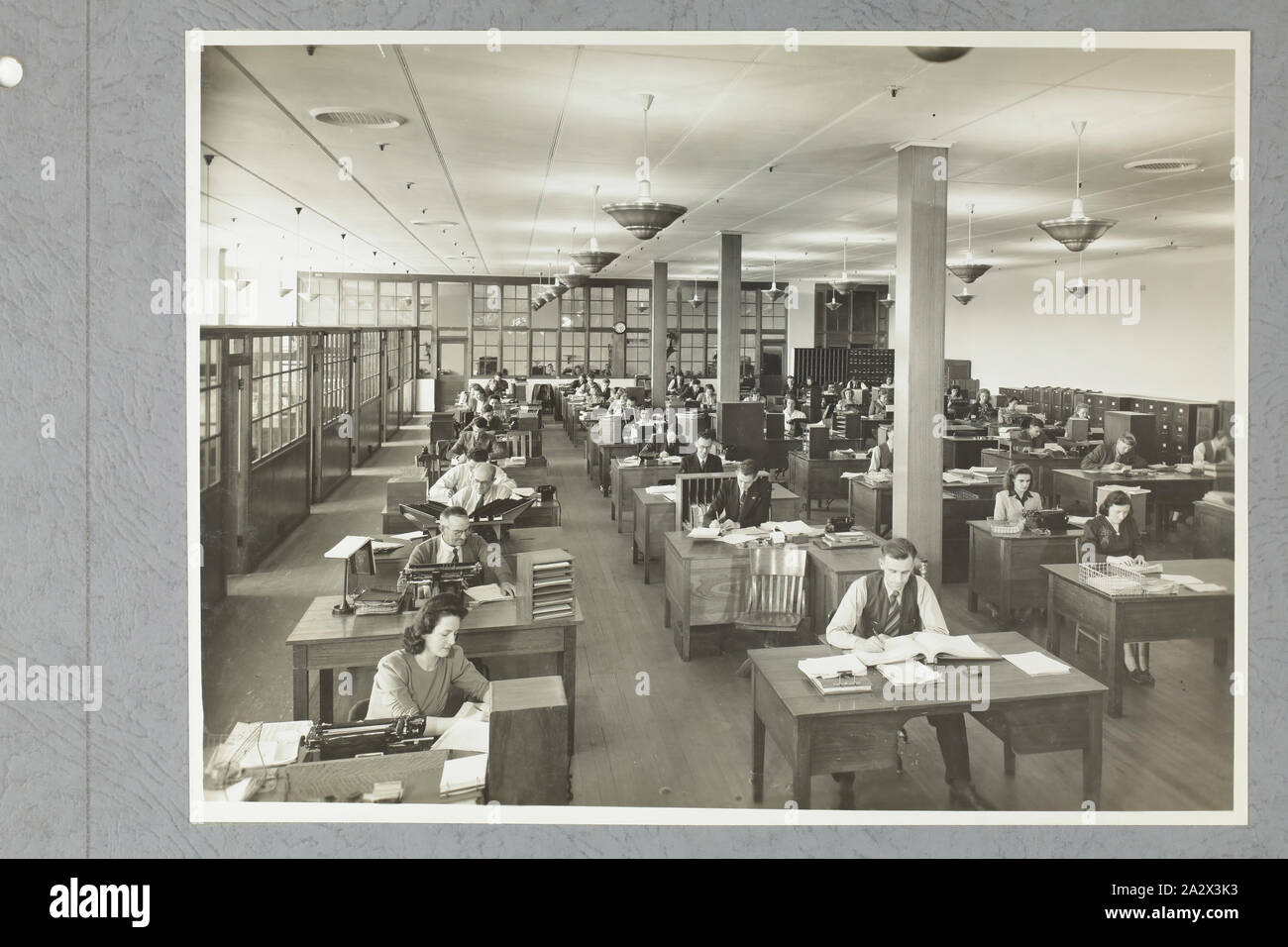 Photograph - International Harvester, Office Interior, Harvester House, Melbourne, 11 Dec 1946, One of four black and white photographs attached to an album page. The page is one of 28 that previously made up a photograph album containing black & white photographs of the International Harvester Company's state branch offices and showrooms throughout Australia. Part of a large collection of glass plate and film negatives, transparencies, photo albums, product catalogues, videos Stock Photo