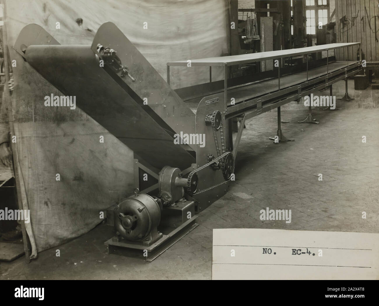 Photograph - Schumacher Mill Furnishing Works, Conveyor, Port Melbourne, Victoria, 1929, Black and white promotional image of a conveyor. It is part of a collection of photographs and marked printer's copy used in the preparation of trade literature promoting products manufactured by the Schumacher Mill Furnishing Works Pty Ltd. The items were originally housed in a wooden filing drawer Stock Photo