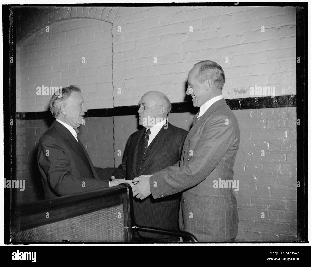 Returning Senators greet one another. Washington, D.C., Jan. 3. Republican Senator William E. Borah, left, seemed happy to see Democratic Senator John H. Bankhead, center, and Millard E. Tydings, as he met them in the Senate subway on their way to today's opening session of the 76th Congress Stock Photo