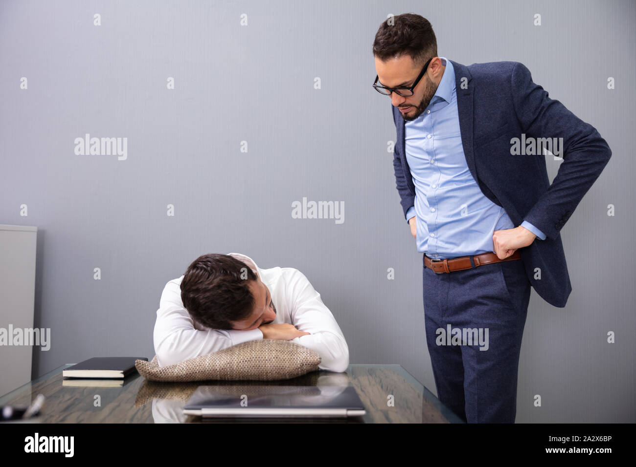 Angry Boss Caught Tired Lazy Employee Sleeping At Workplace Stock Photo