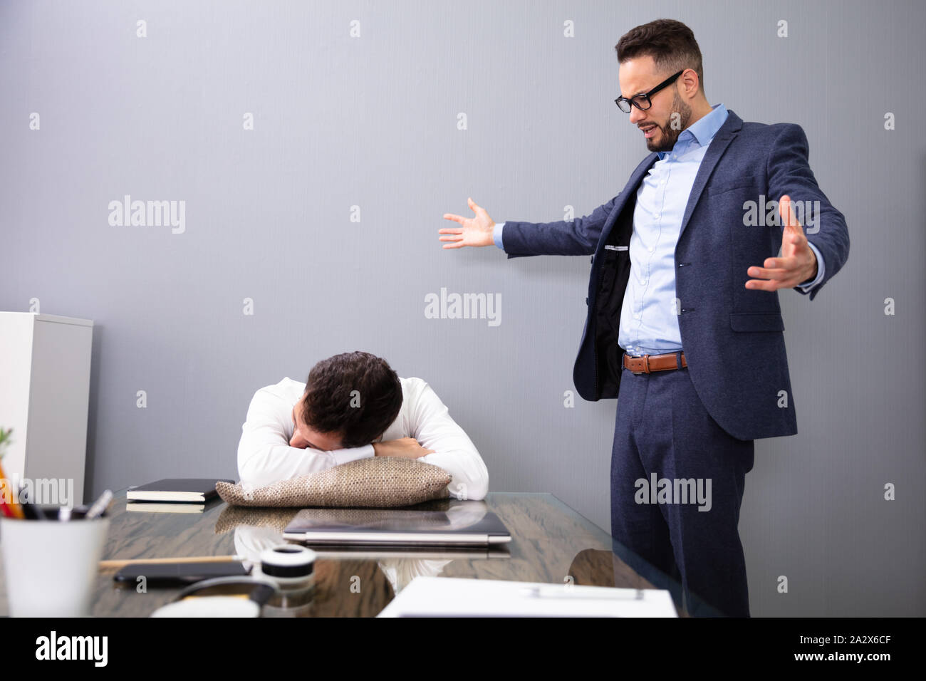 Angry Boss Caught Tired Lazy Employee Sleeping At Workplace Stock Photo