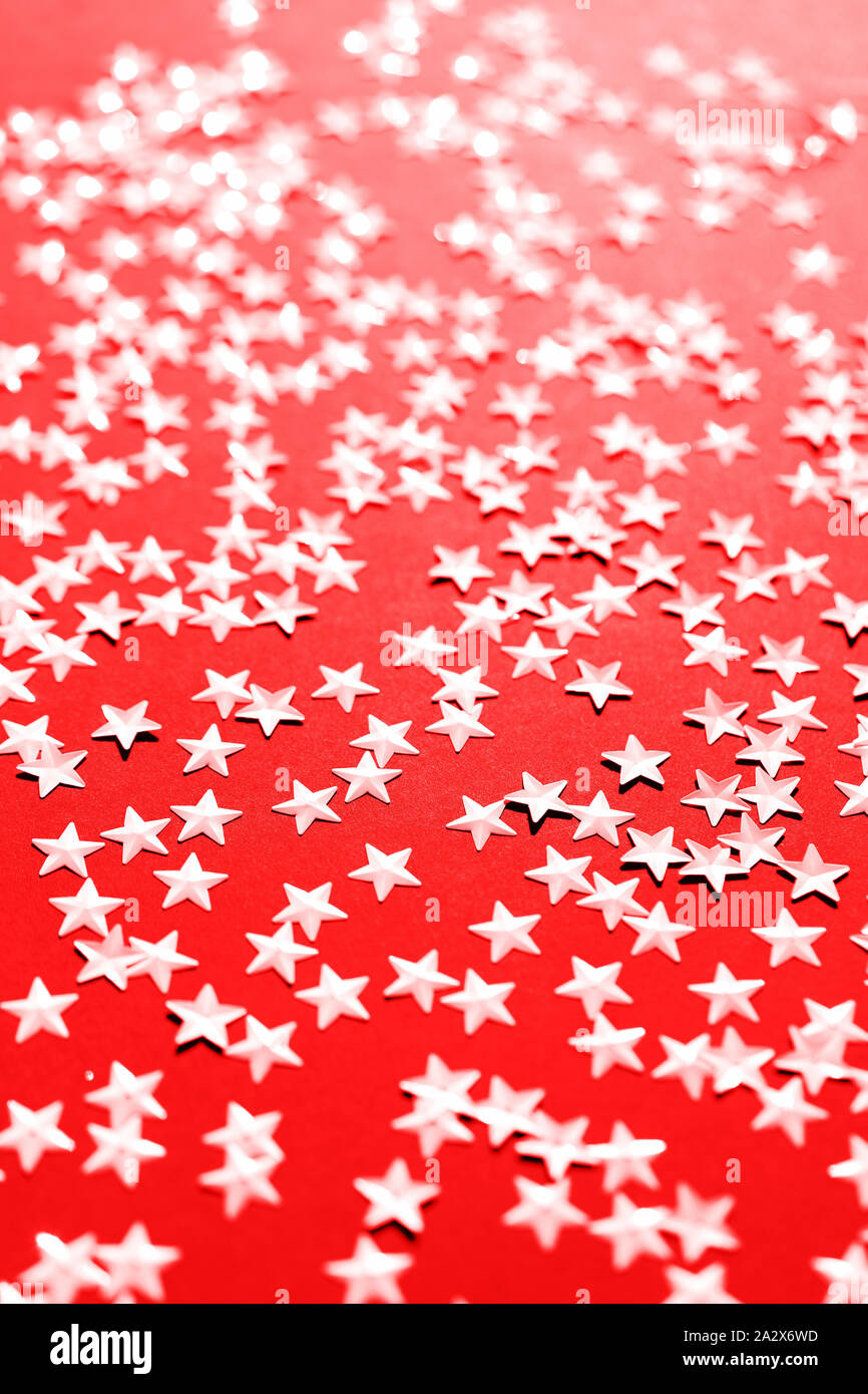 Silver star sparkles on red backdrop. Festive Christmas concept Stock Photo