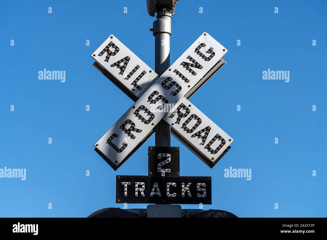 Old railroad crossing two tracks signal sign. Stock Photo