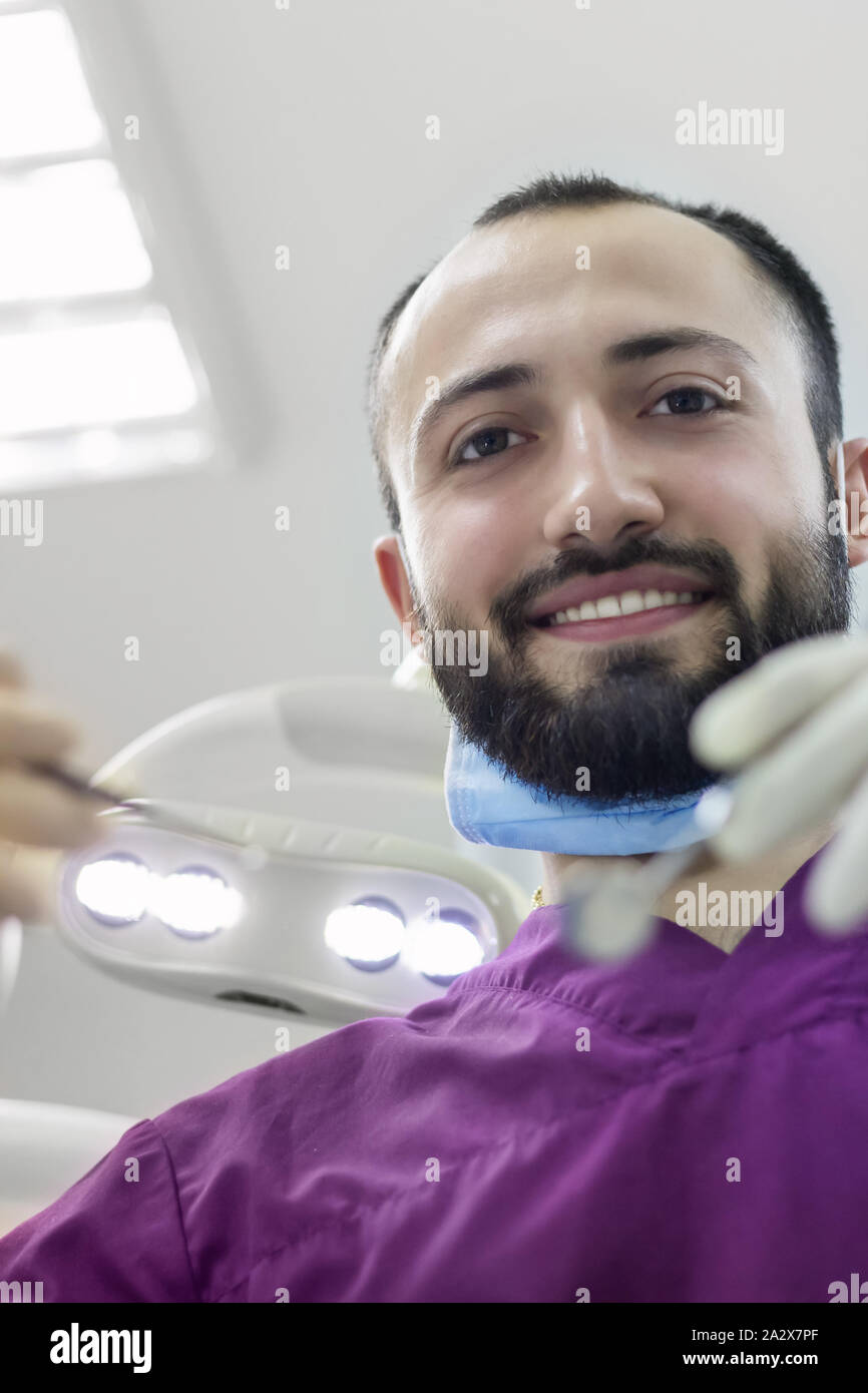 dentist doctor happy examines a patient's mouth teeth professional smile Stock Photo Alamy