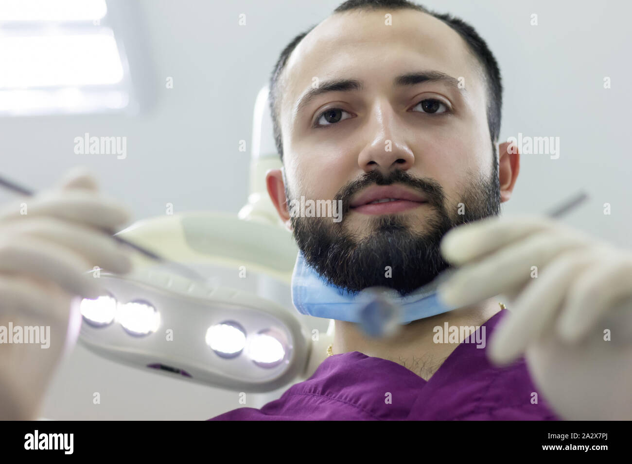 dentist doctor happy examines a patient's mouth teeth professional