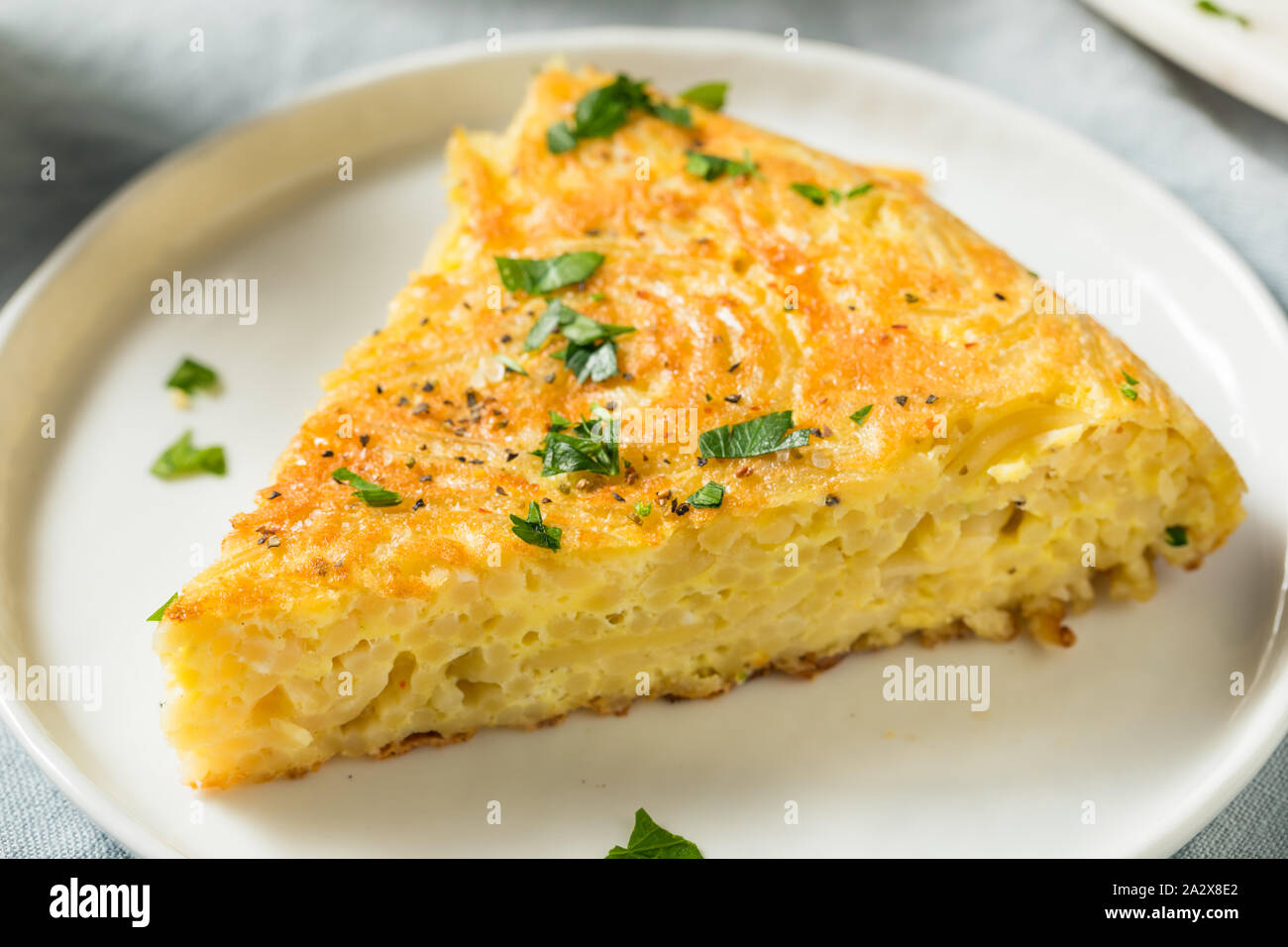 Homemade Spaghetti Omelette with Eggs and Parsley Stock Photo