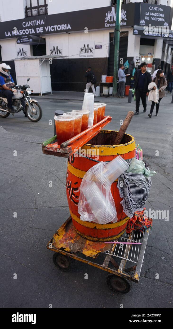 Painted barrel street vendor beverage cart at corner of Victoria and Balderas streets in Mexico City, in front of Cantina La Mascota de Victoria. Stock Photo