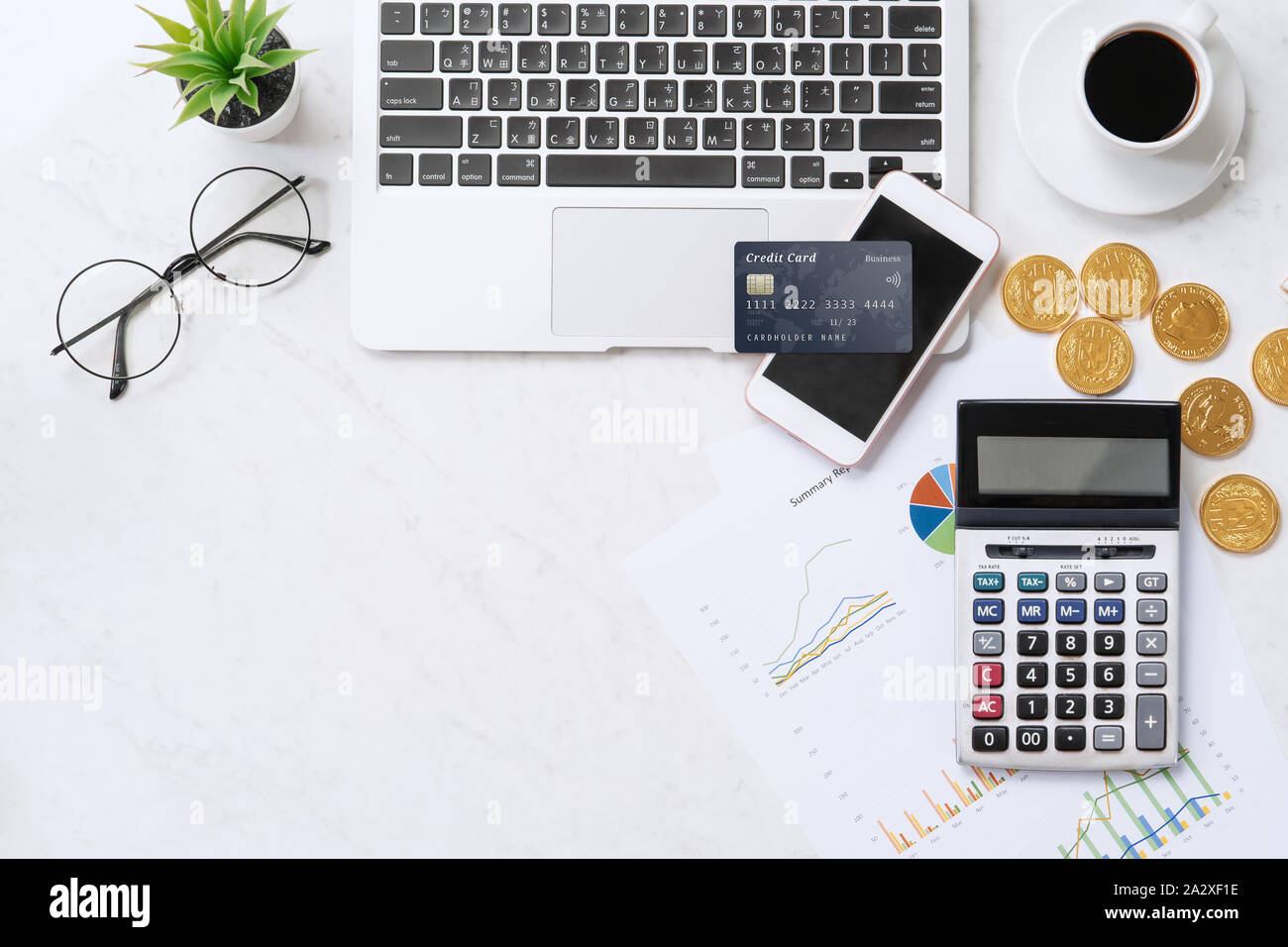 Concept of online payment with credit card with smart phone, laptop computer on office desk on clean bright marble table background, top view, flat la Stock Photo