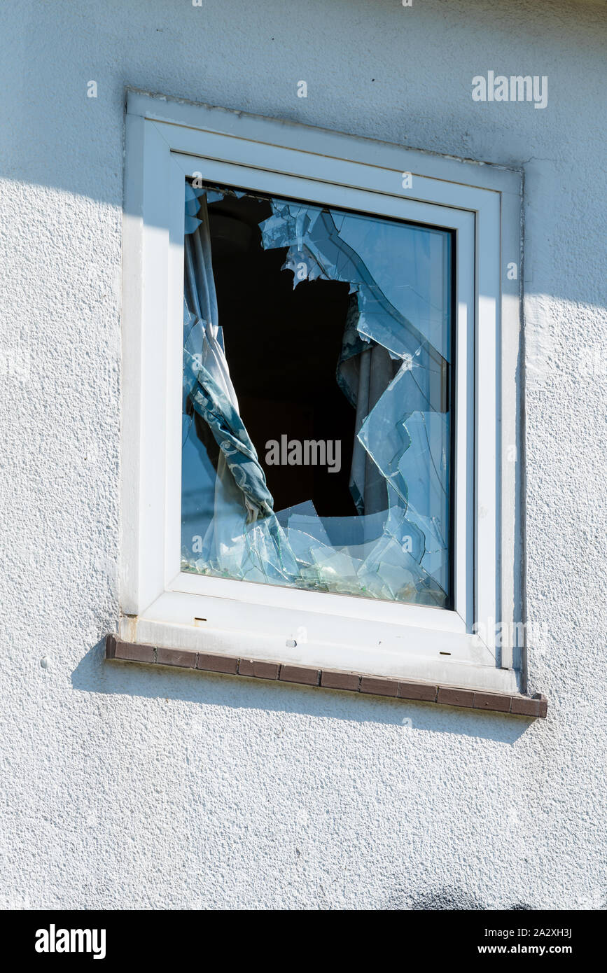 window with cracked glass after stone throw vandalism Stock Photo - Alamy