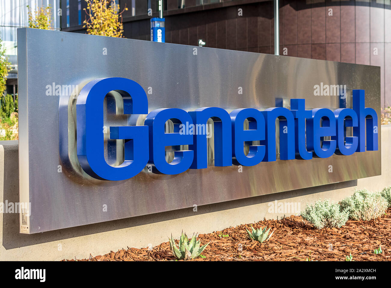 Genentech company sign at biotechnology corporation headquarters campus in Silicon Valley. Genentech is subsidiary of Swiss Roche Stock Photo