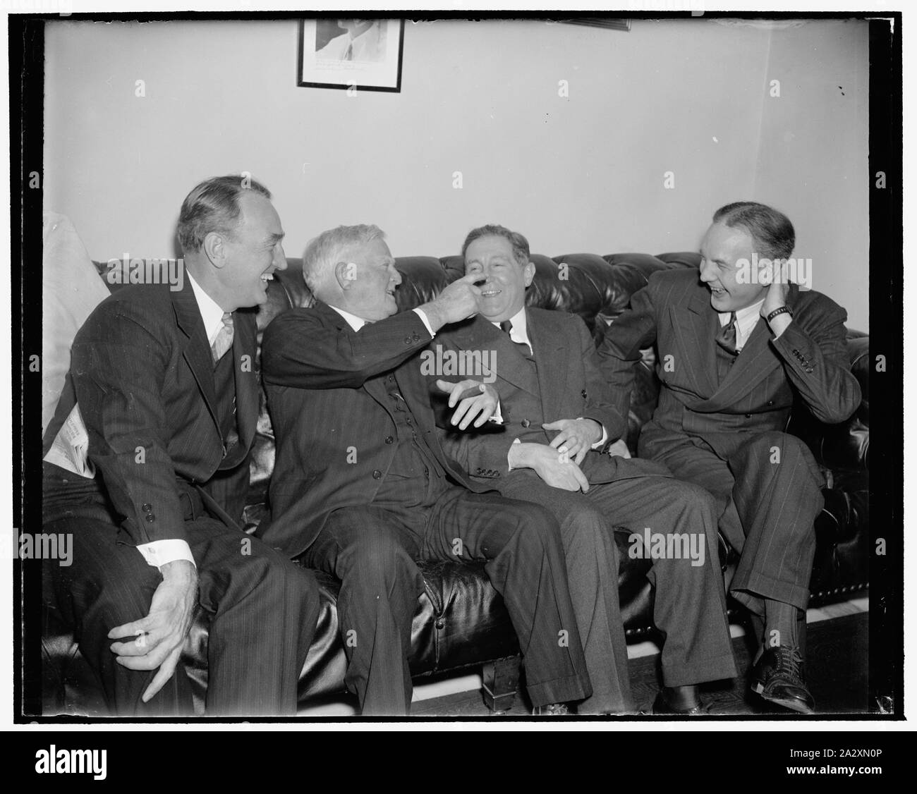Rookie Senators engage in first 'Bull' session with Vice President Garner. Washington, D.C., Dec. 19. This session's crop of rookie Senators were initiated today at an impromptu conference with Vice President John N. Garner. Naturally they were regaled by the wily Texas Legislator with some of his famous stories. Left to right: Senator James M. Mead, New York; Vice President Garner, Senator Sheridan Downey, California; and Senator D. Worth Clark, Idaho, 12/19/38 Stock Photo