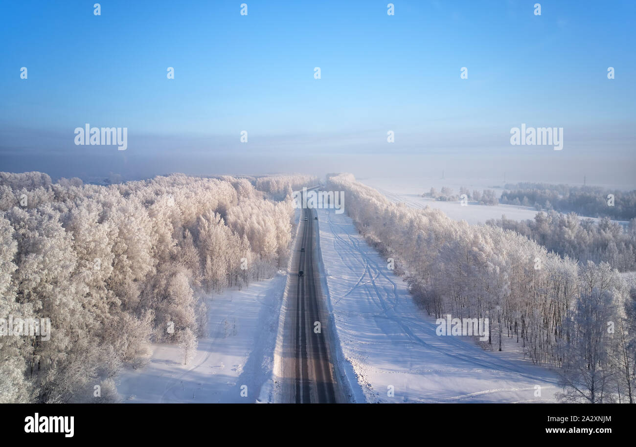 Siberian rural asphalt road under the snow. Siberian rural winter ...