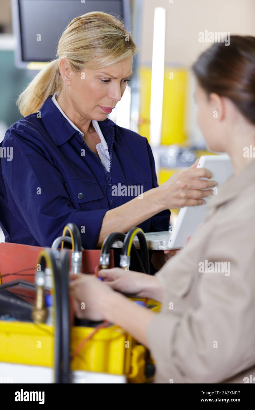 female trainer inspecting information from the tablet Stock Photo