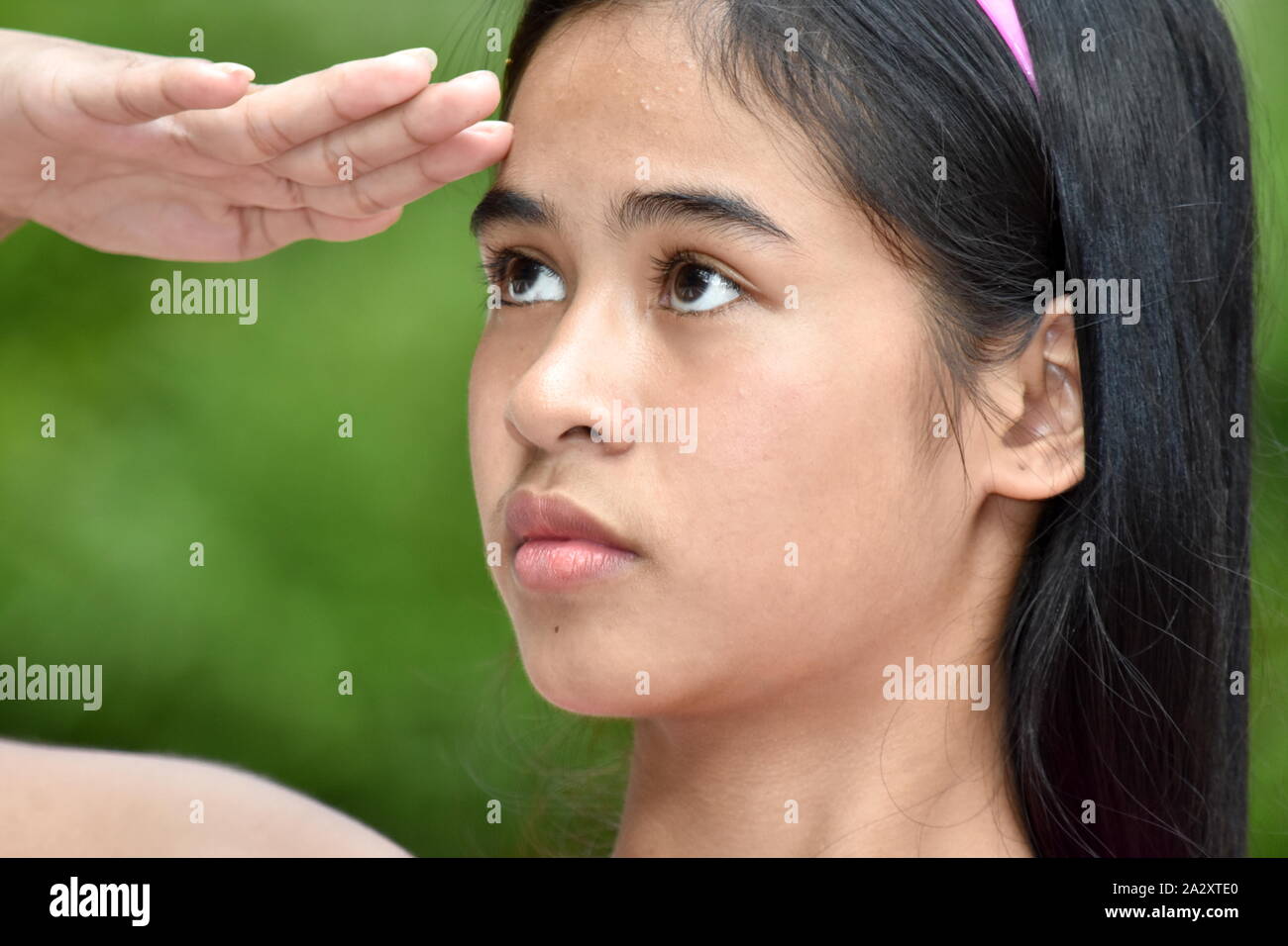 An A Youthful Asian Girl Saluting Stock Photo
