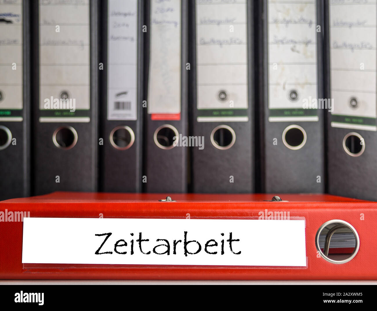 Temporary work - red folder in the office Stock Photo - Alamy