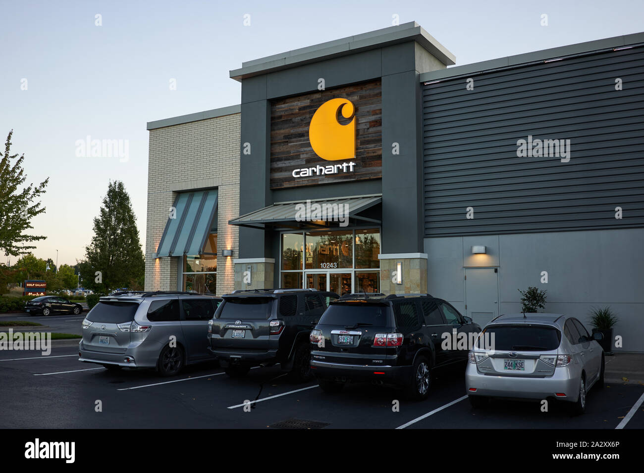 Carhartt Store in Portland's Cascade Station Shopping Center at dusk. Carhartt, Inc., is an American apparel company known for its work clothes. Stock Photo
