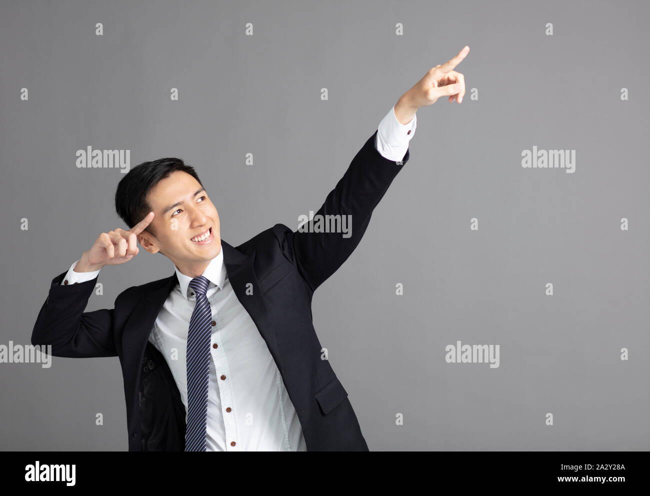 smiling Business man pointing upwards Stock Photo