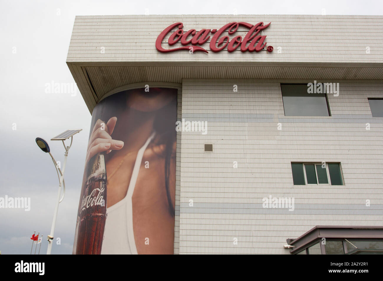 The Coca-cola logo is seen at the COFCO-Coca-cola joint venture's Beijing facility in suburban BDA on July 29, 2019. Stock Photo