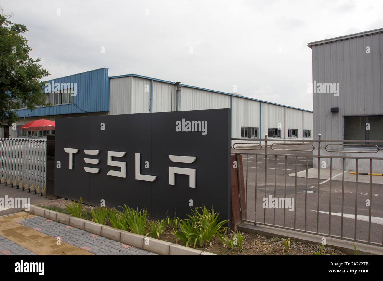 The Tesla logo is seen at Tesla's Beijing facility in suburban Beijing Economic-Technological Development Area on July 29, 2019. Stock Photo
