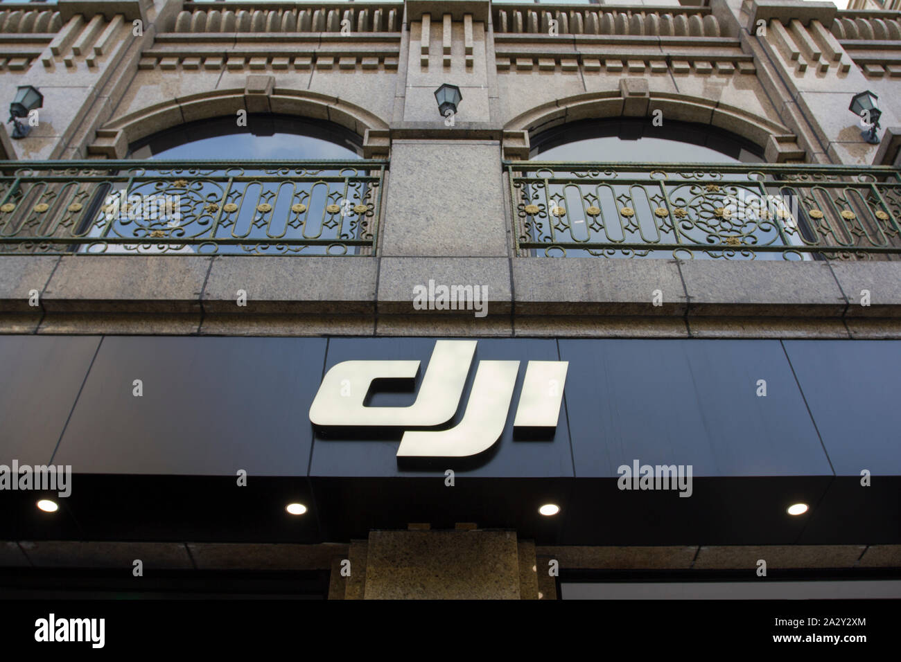 The DJI logo at a DJI store in downtown Shanghai. DJI is a Chinese technology company known as a manufacturer of unmanned aerial vehicles. Stock Photo