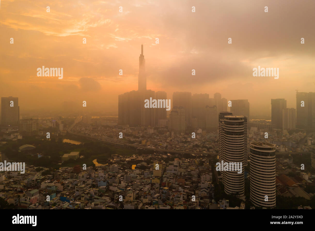 Beautiful aerial urban sunrise in Southeast Asia due to an extreme air pollution level. Ho Chi