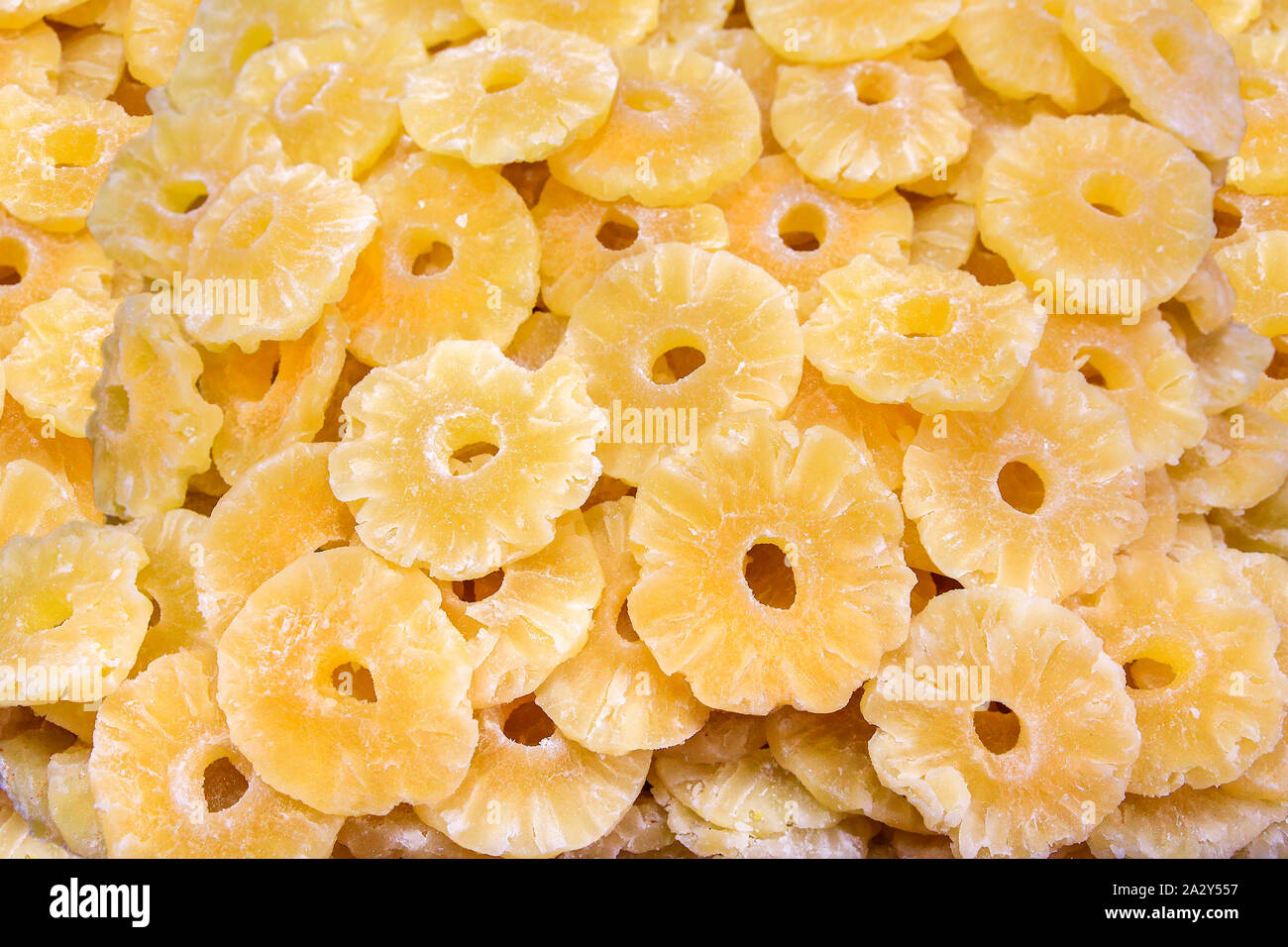 Heap of dry yellow pineapple slices for sale at market Stock Photo