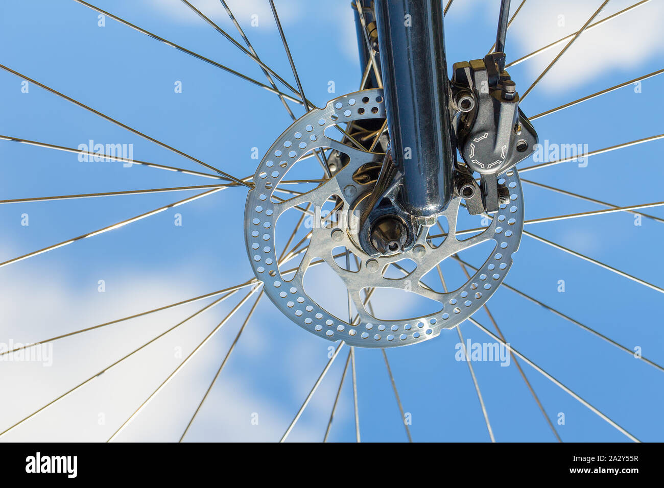 Mountanbike wheel with disc brake up in the blue sky Stock Photo