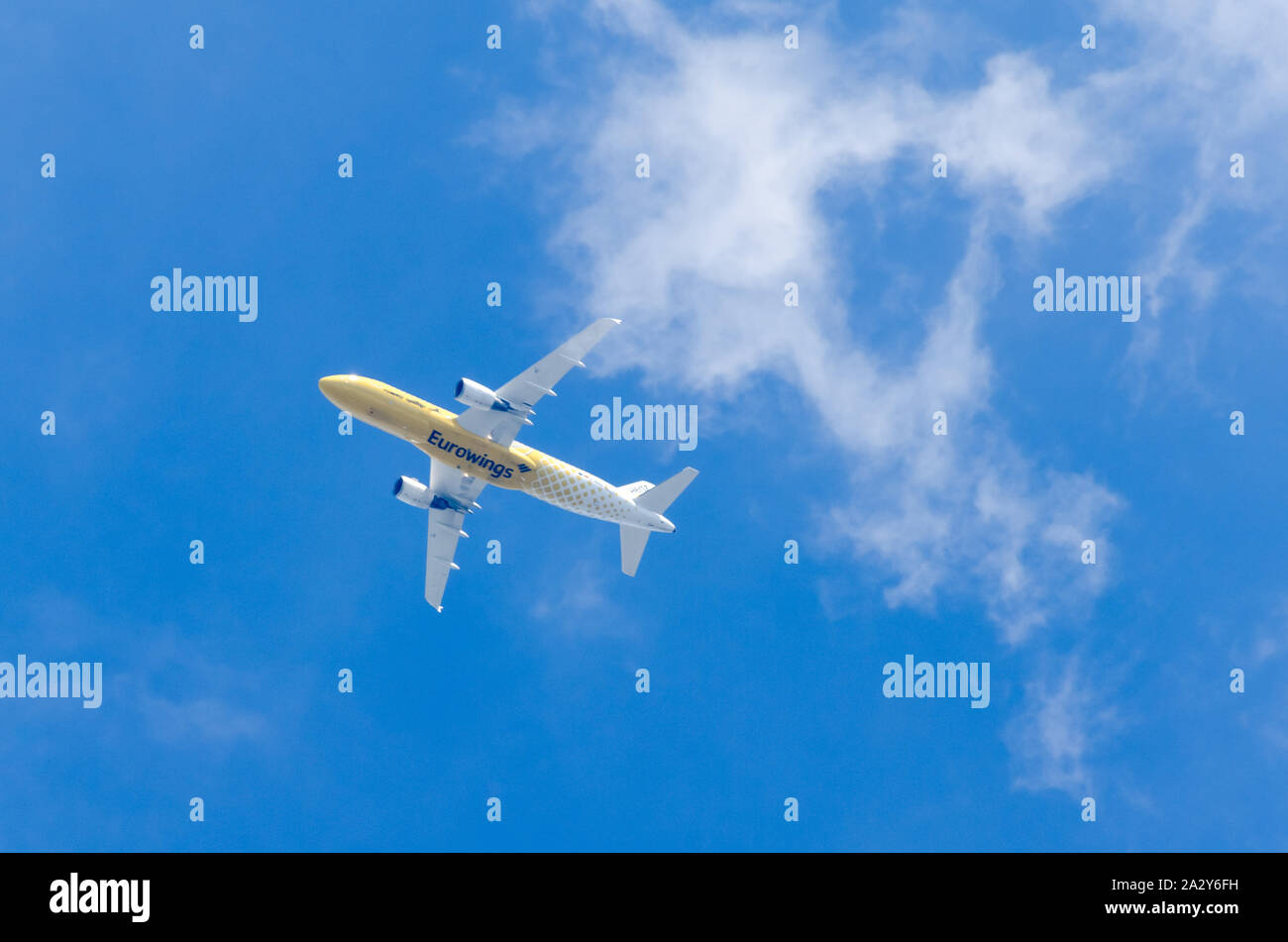 Eurowings Airbus A319 in mid-air with yellow Hertz livery against blue ...