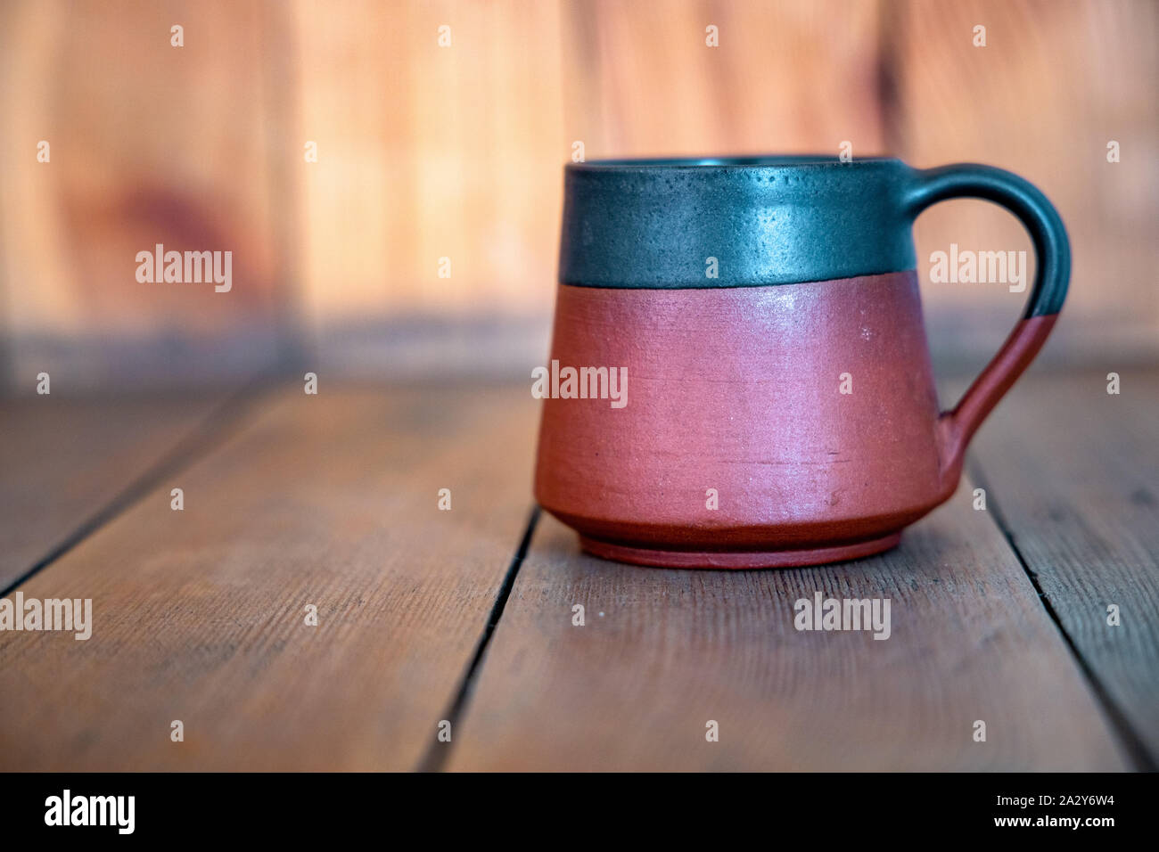 A cup of tea placed on a wooden table. Stock Photo