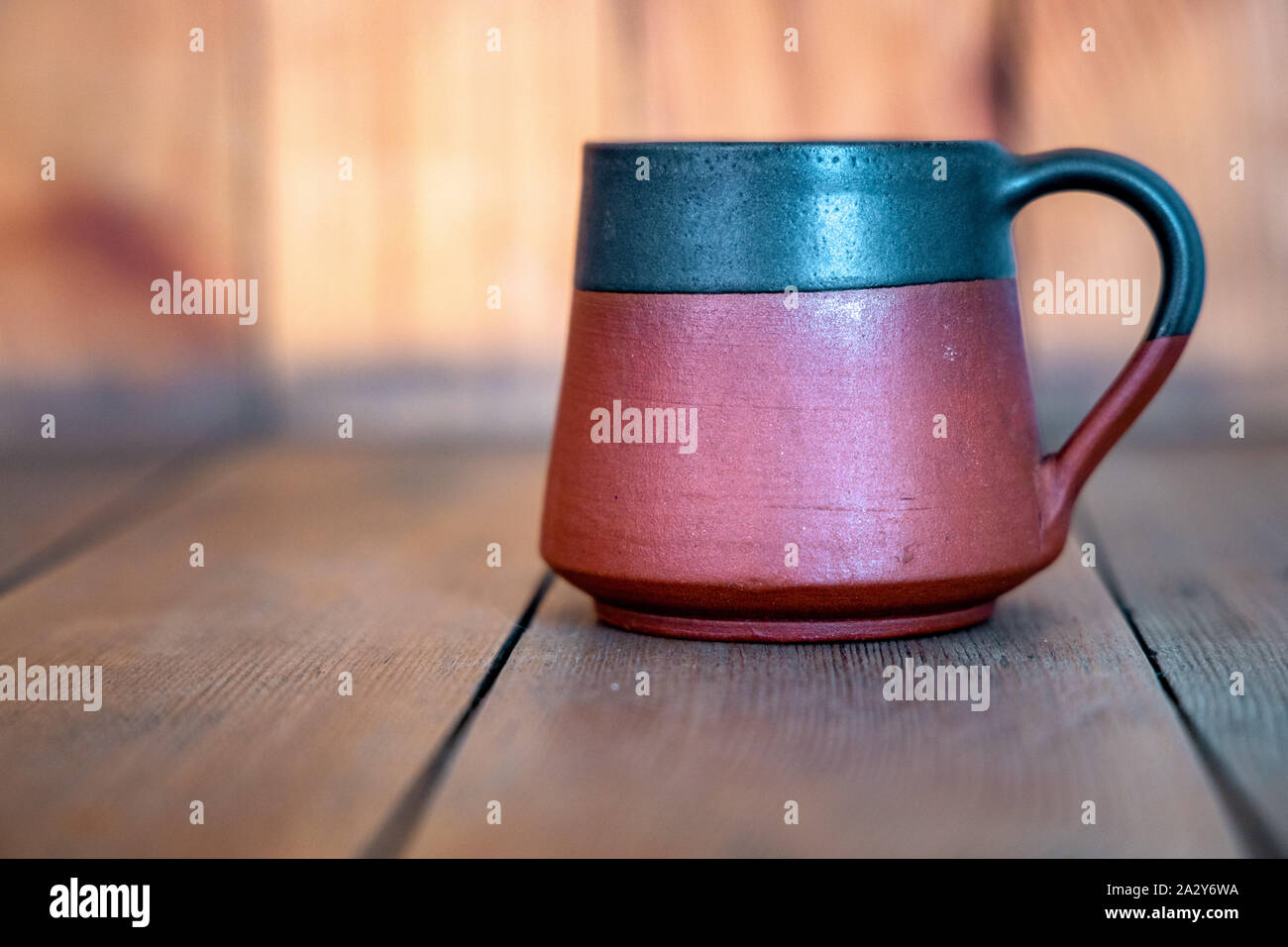 A cup of tea placed on a wooden table. Stock Photo