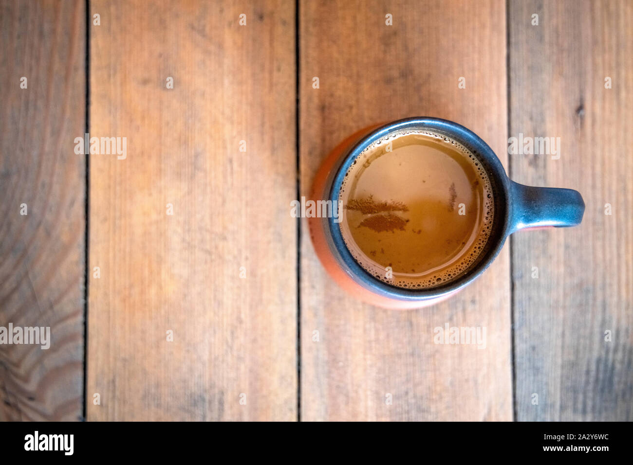 A cup of tea placed on a wooden table. Top view Stock Photo