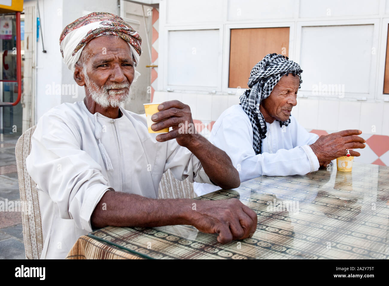 Handsome senior men with hijab drinking coffee and tea Stock Photo