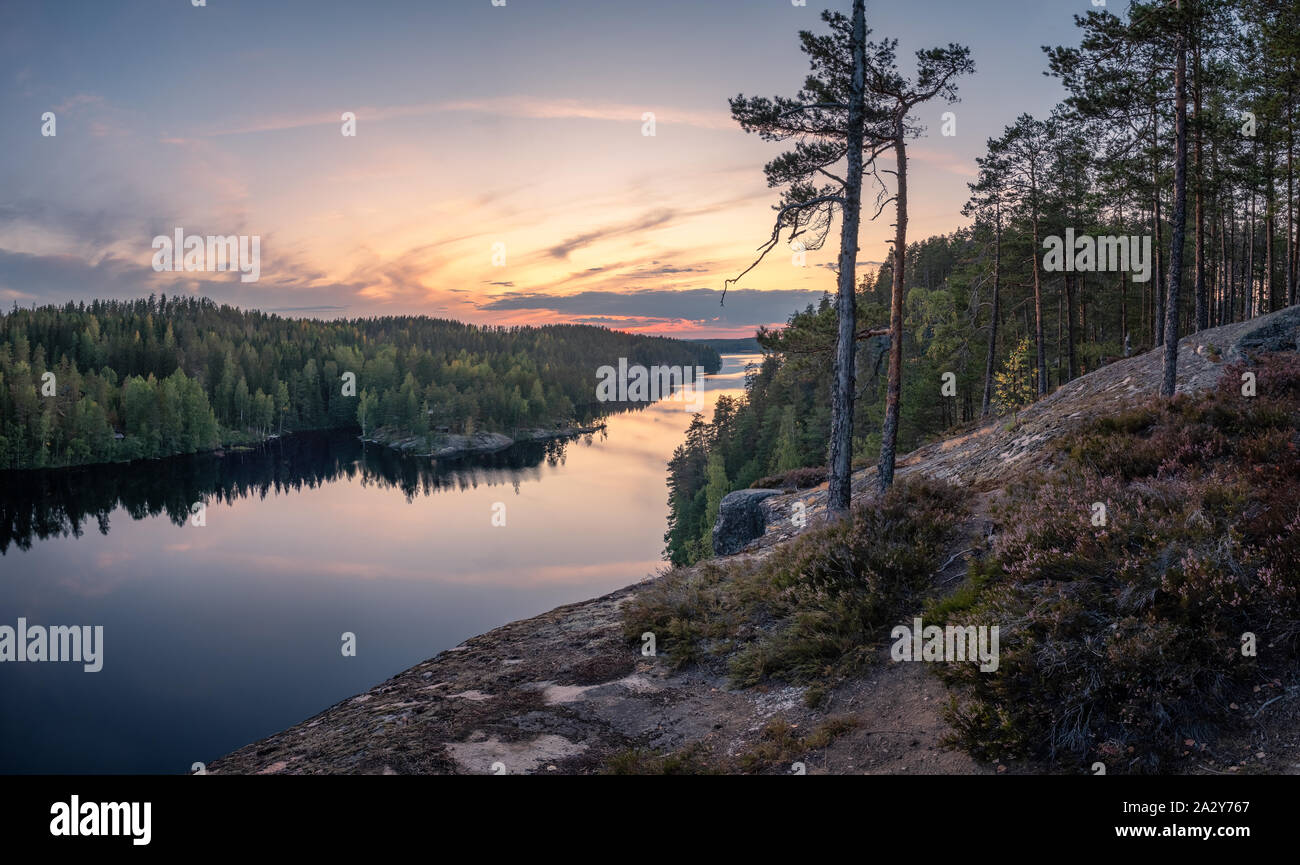 Scenic forest landscape with tranquil mood and idyllic sunset at summer evening in Finland Stock Photo