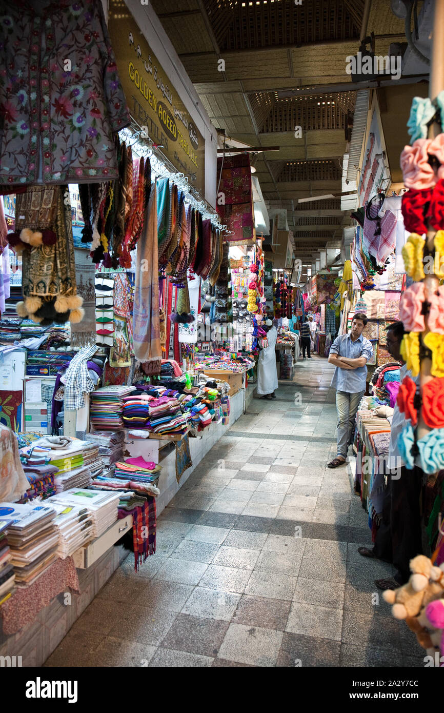 Variety of traditional carpets and clothing for sale on the souk of