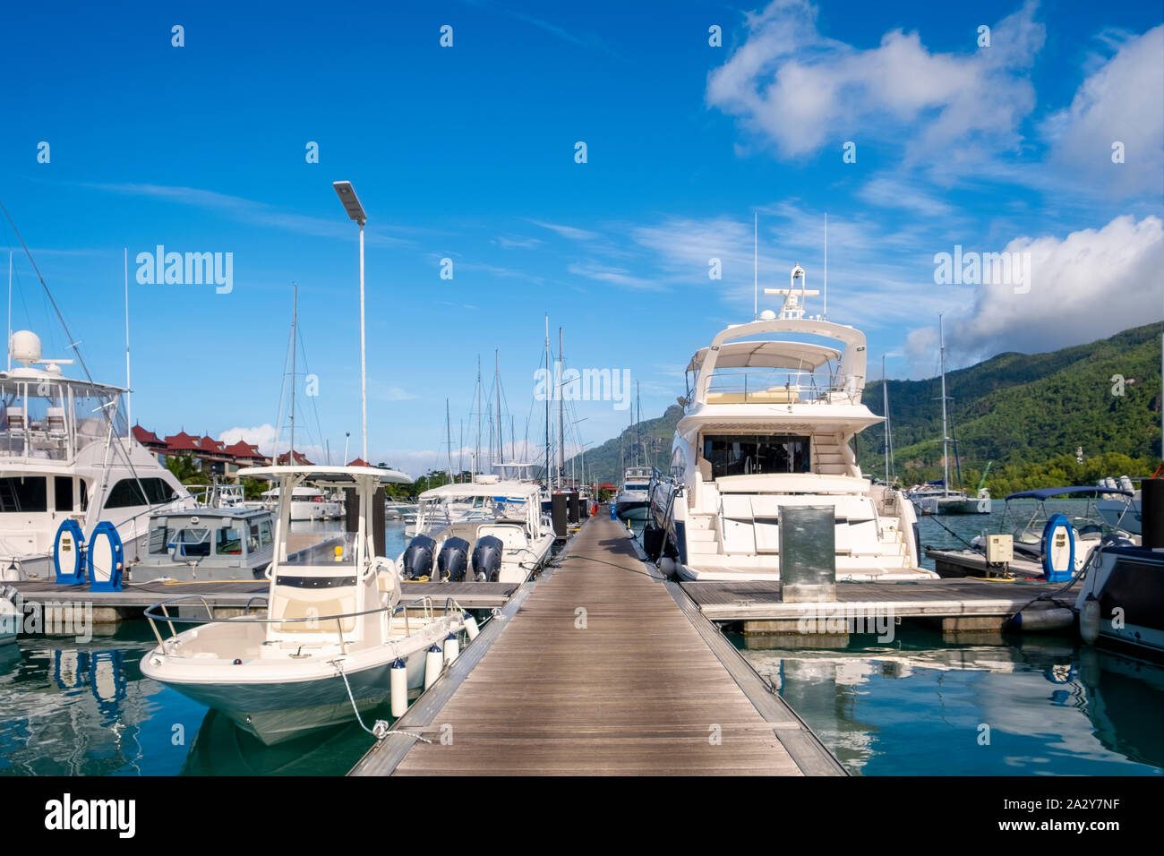 Luxury yachts and Boats in sunny summer day at marina of Eden Island, Mahe, Seychelles Stock Photo