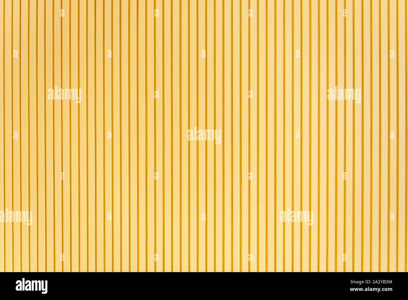 Wall style pattern vertical dark and light yellow color made of wood. Background, wallpaper, and texture. Stock Photo