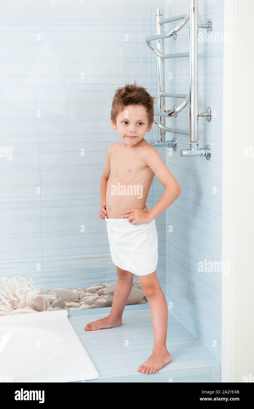 https://c8.alamy.com/comp/2A2YE4B/healthy-small-cute-boy-wearing-white-towel-standing-in-blue-clean-bathroom-2A2YE4B.jpg