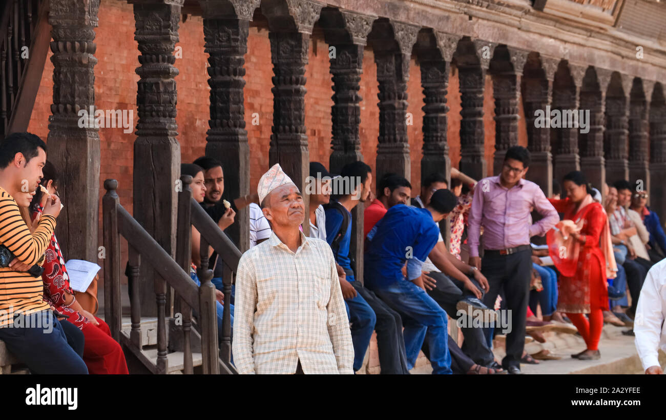 A middle-aged Nepali man admiring architecture and temples at Bhaktapur Durbar Square Stock Photo