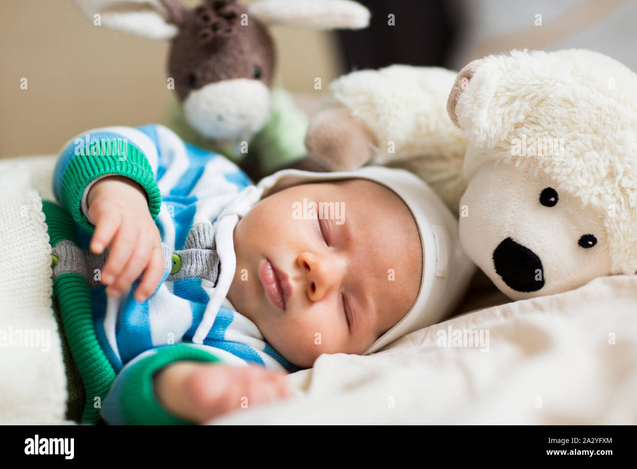 Moments of tranquility: Lovely baby boy sleeping. Stock Photo