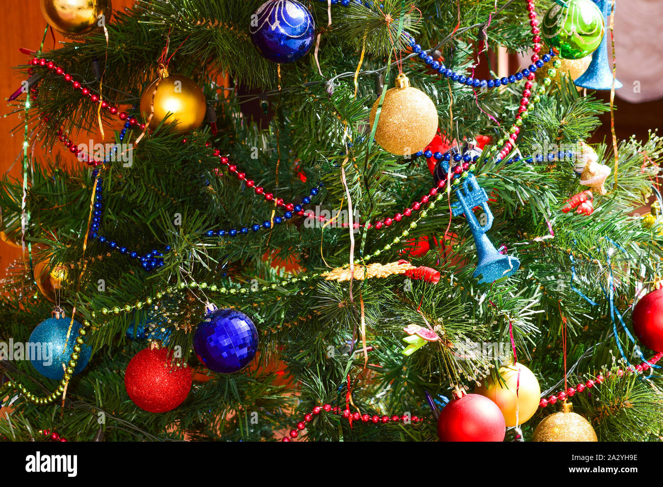 Christmas toys and ornaments on the Christmas tree. Tinsel, balls and ...