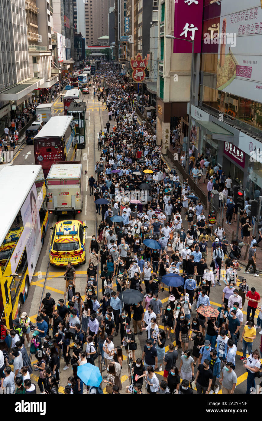 Hong Kong. 4 October 2019. Large peaceful march by thousands of pro-democracy supporters through Central business district of Hong Kong this afternoon. March was in protest against Chief Executive Carrie Lam's use of Emergency Powers to ban the wearing of masks during protests. Iain Masterton/Alamy Live News. Stock Photo