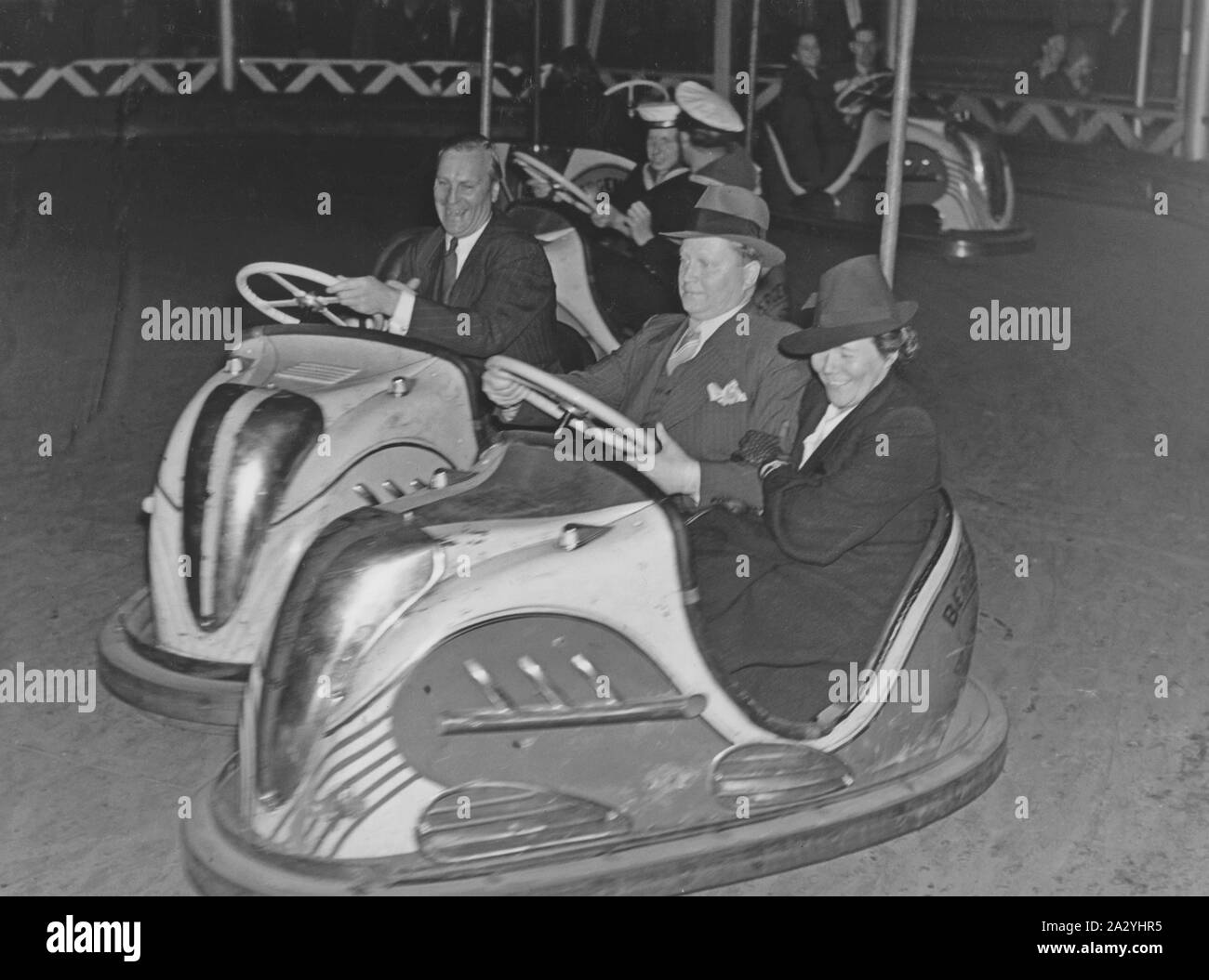 Amusement park in the 1940s. No matter old or young, bumper cars are one of the favorite attractions. Pictured a older couple driving and having fun. Sweden 1940s. Stock Photo
