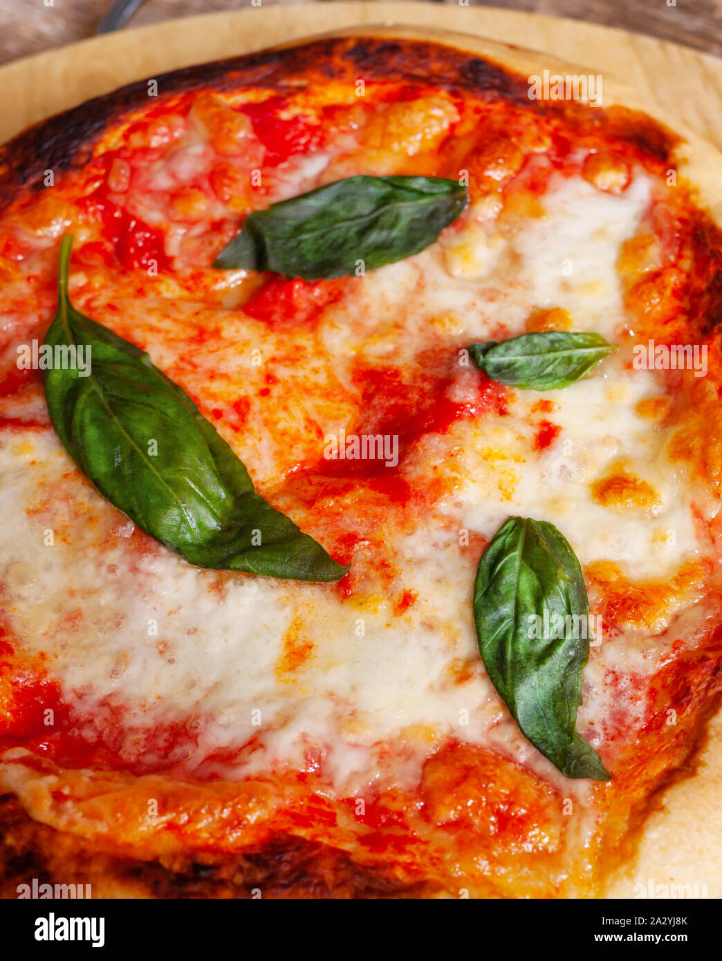 Fresh Homemade Italian Pizza Margherita with basil on rustic background. Stock Photo