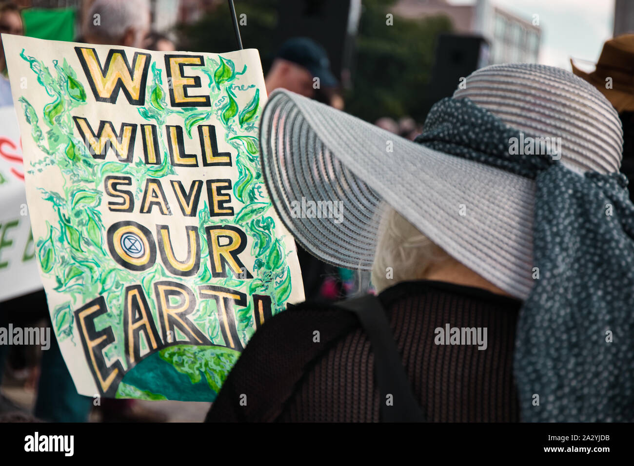 Woman in wide brimmed hat holding climate change placard, 20th September global climate strike, Old Market Square, Nottingham, East Midlands, England Stock Photo