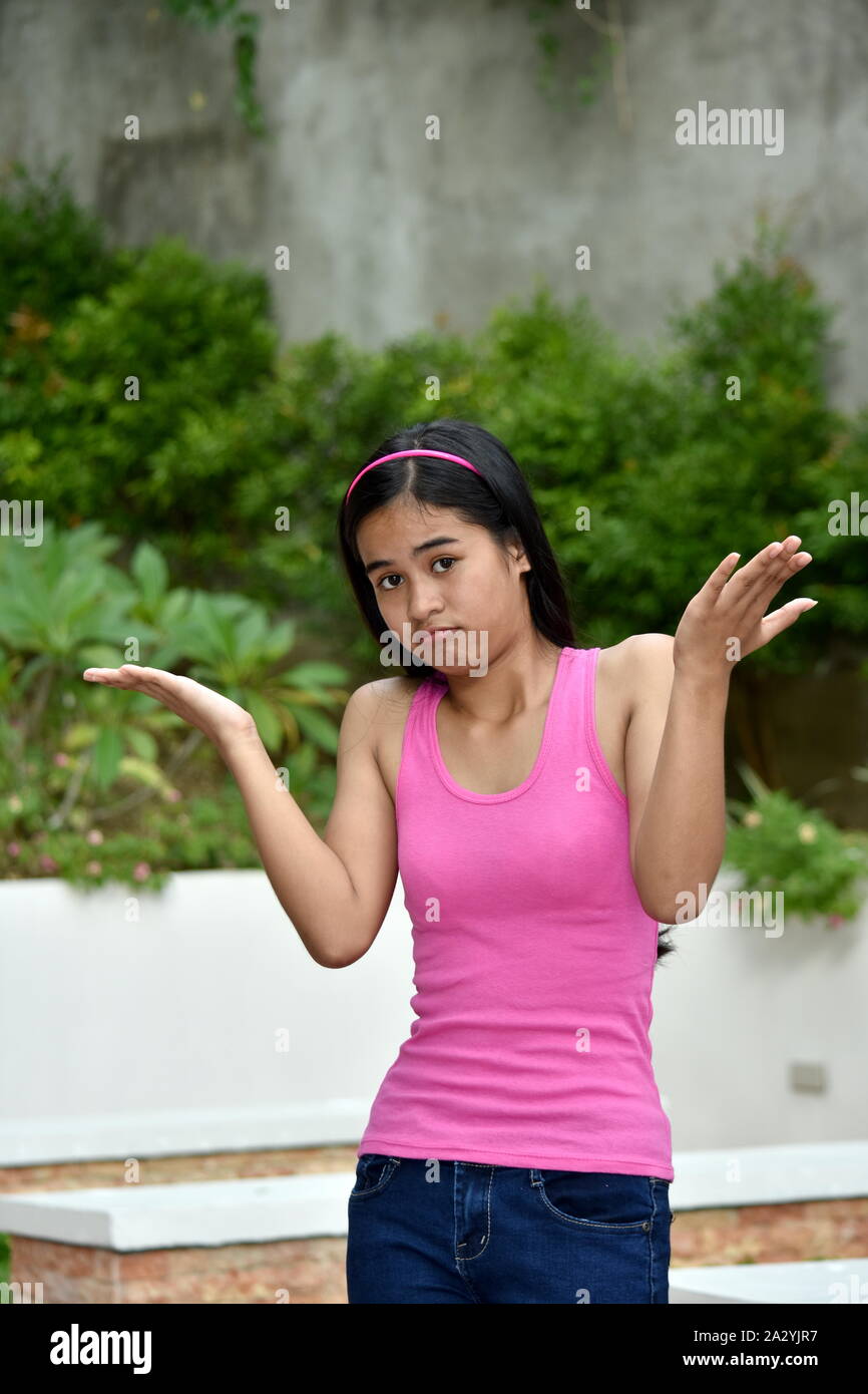 An Undecided Youthful Asian Teenager Girl Stock Photo